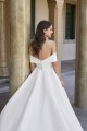 Stretch Mikado A-line gown with off the shoulder neckline that creates a bow detail. 