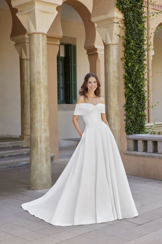 Stretch Mikado A-line gown with off the shoulder neckline that creates a bow detail. 
